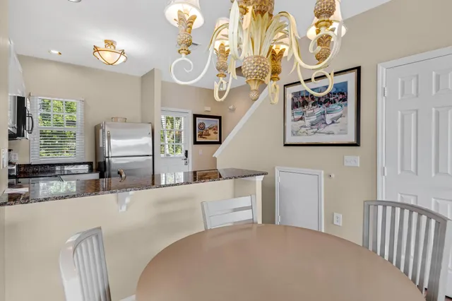 a kitchen with a center island and stainless steel appliances