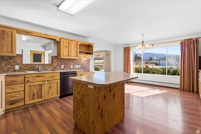 217 East 400 South Spring City, UT 84662 - Photo 11 of 71 Kitchen featuring a chandelier, dishwasher, baseboard heating, a kitchen island, and a mountain view