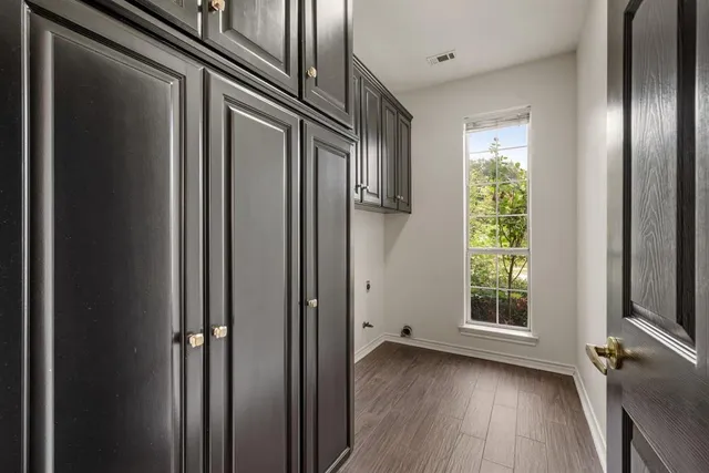 a view of hallway with windows and wooden floor