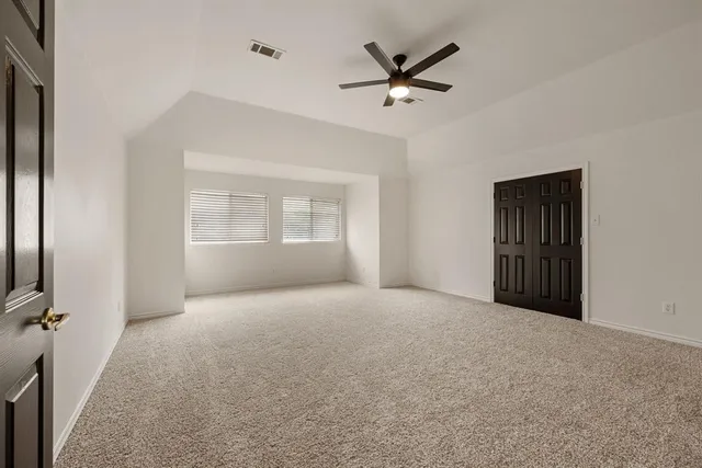 a view of a livingroom with a ceiling fan and window
