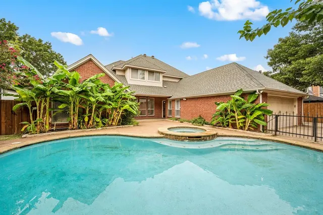 a view of a house with swimming pool and a yard