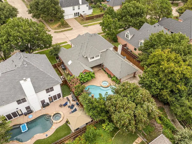 an aerial view of a house with garden space and street view