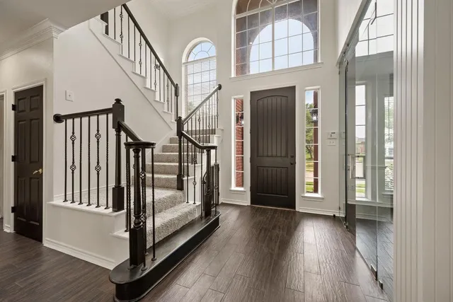 a view of entryway and hall with wooden floor