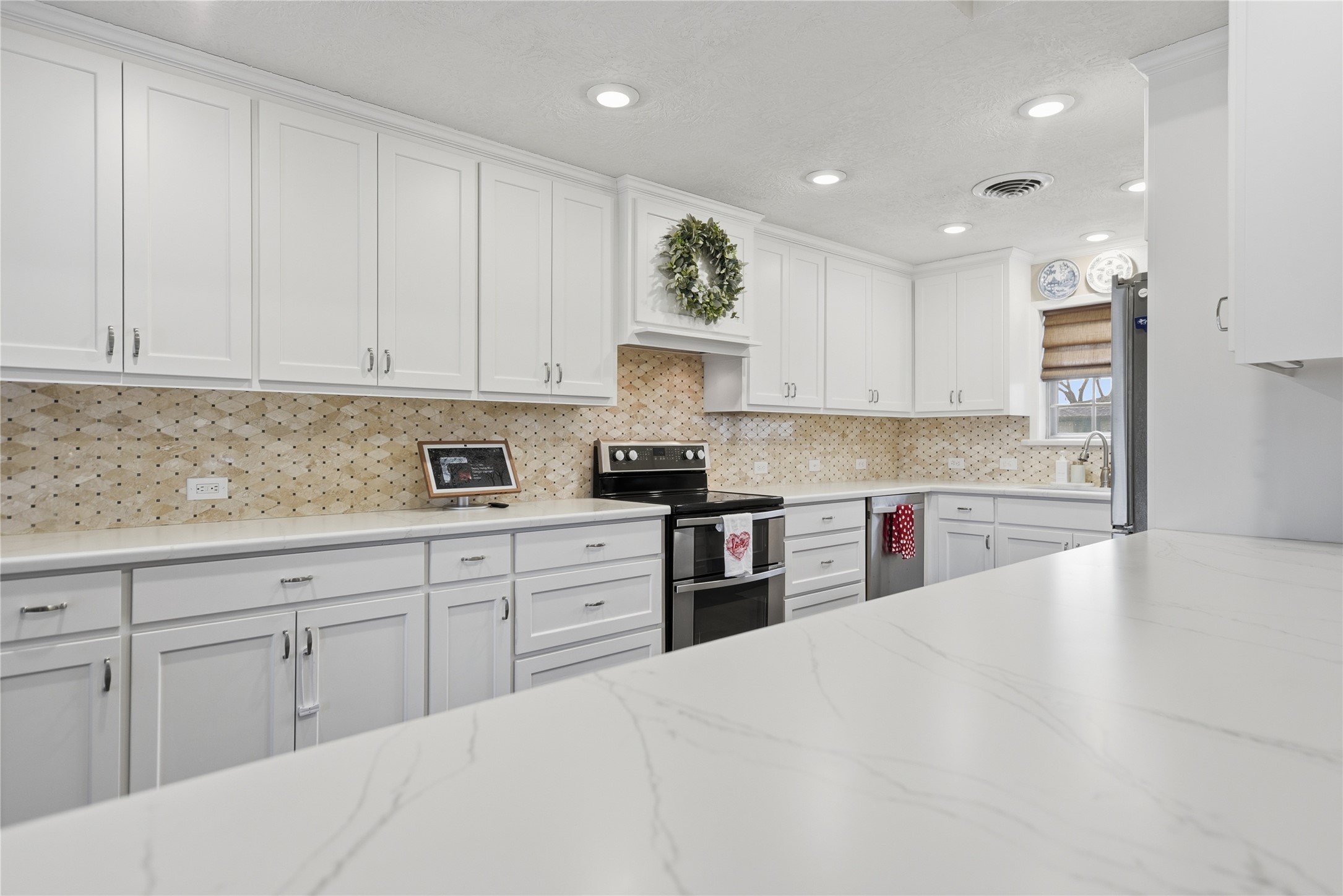 2007 Geney Street Brenham, TX 77833 - Photo 1 of 18 a kitchen with granite countertop white cabinets and stainless steel appliances