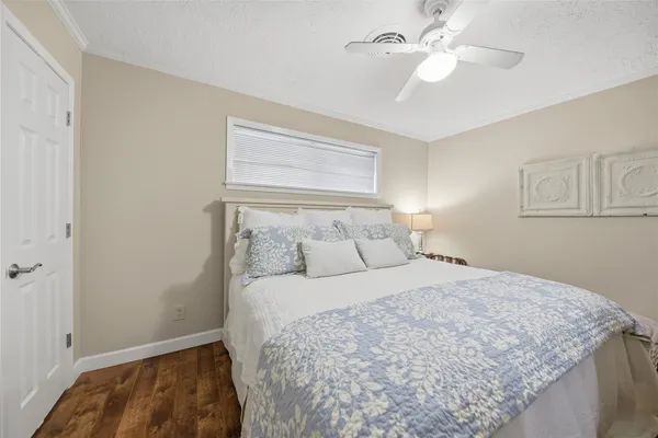a bedroom with a bed and a ceiling fan