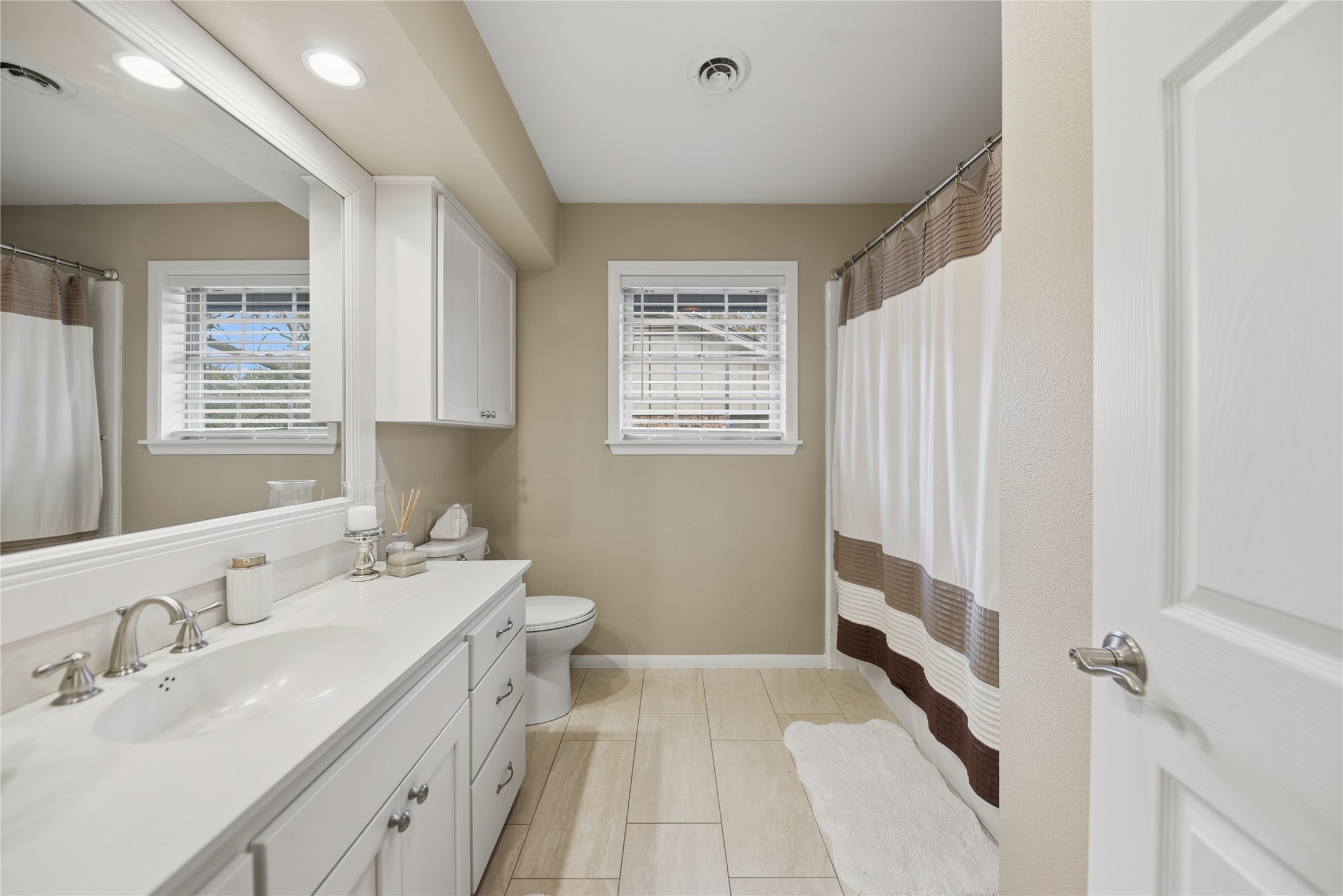 2007 Geney Street Brenham, TX 77833 - Photo 14 of 18 a spacious bathroom with a double vanity sink a mirror and a bathtub