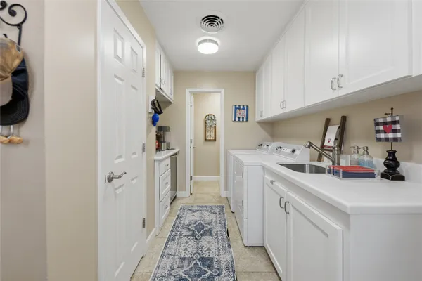 a kitchen with refrigerator and cabinets