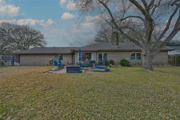 a front view of a house with garden and patio