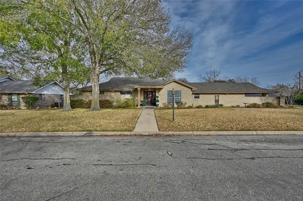 a front view of house with a garden