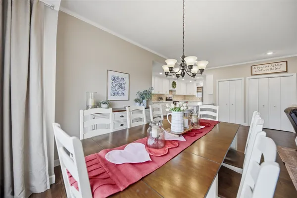 a view of a dining room with furniture and chandelier