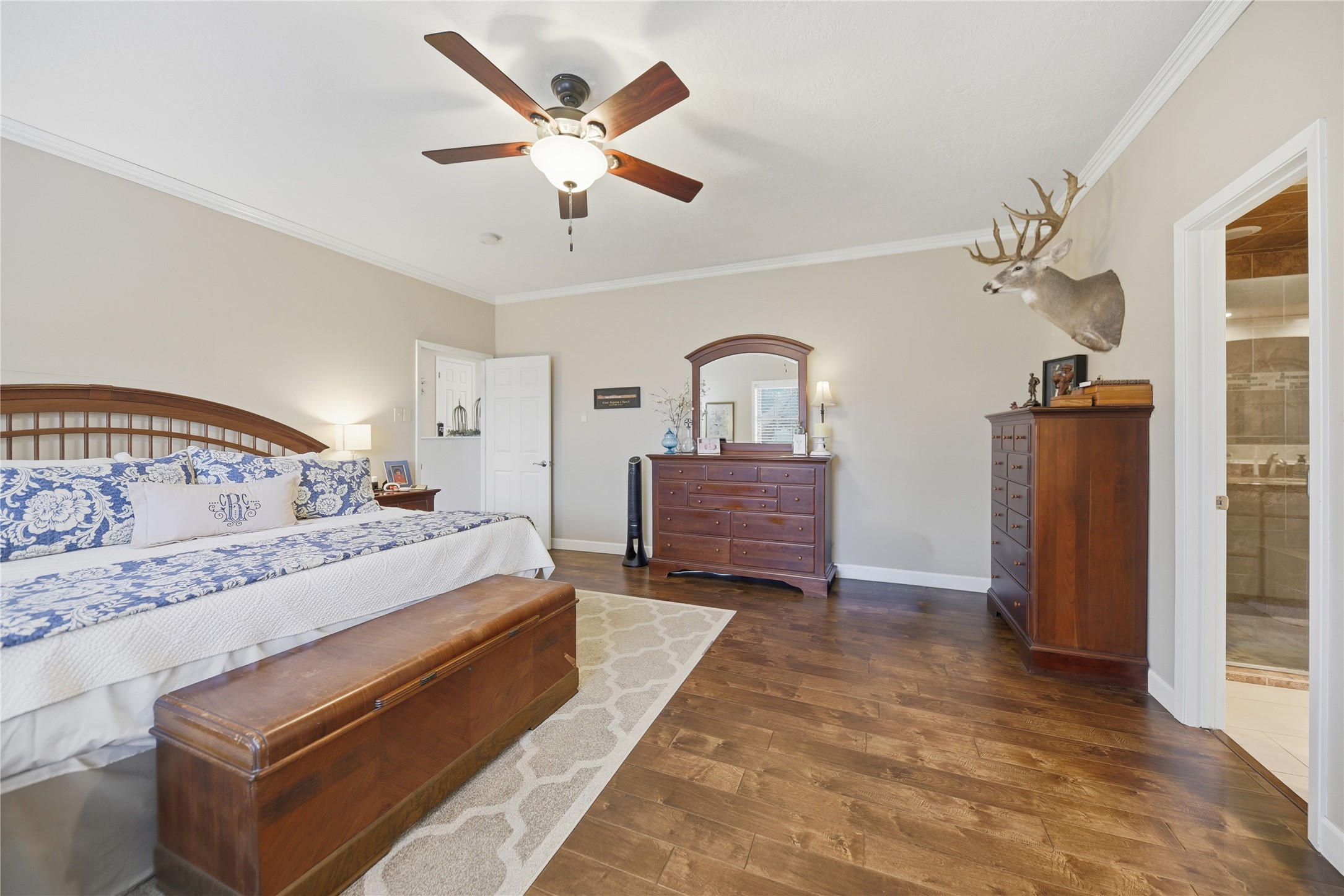 2007 Geney Street Brenham, TX 77833 - Photo 10 of 18 a spacious bedroom with a bed ceiling fan and a window