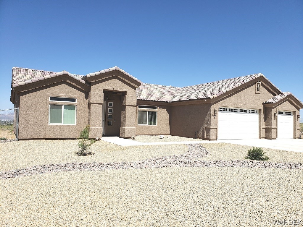 3681 Bacobi Road Golden Valley, AZ 86413 - Photo 1 of 17 a front view of a house with a yard