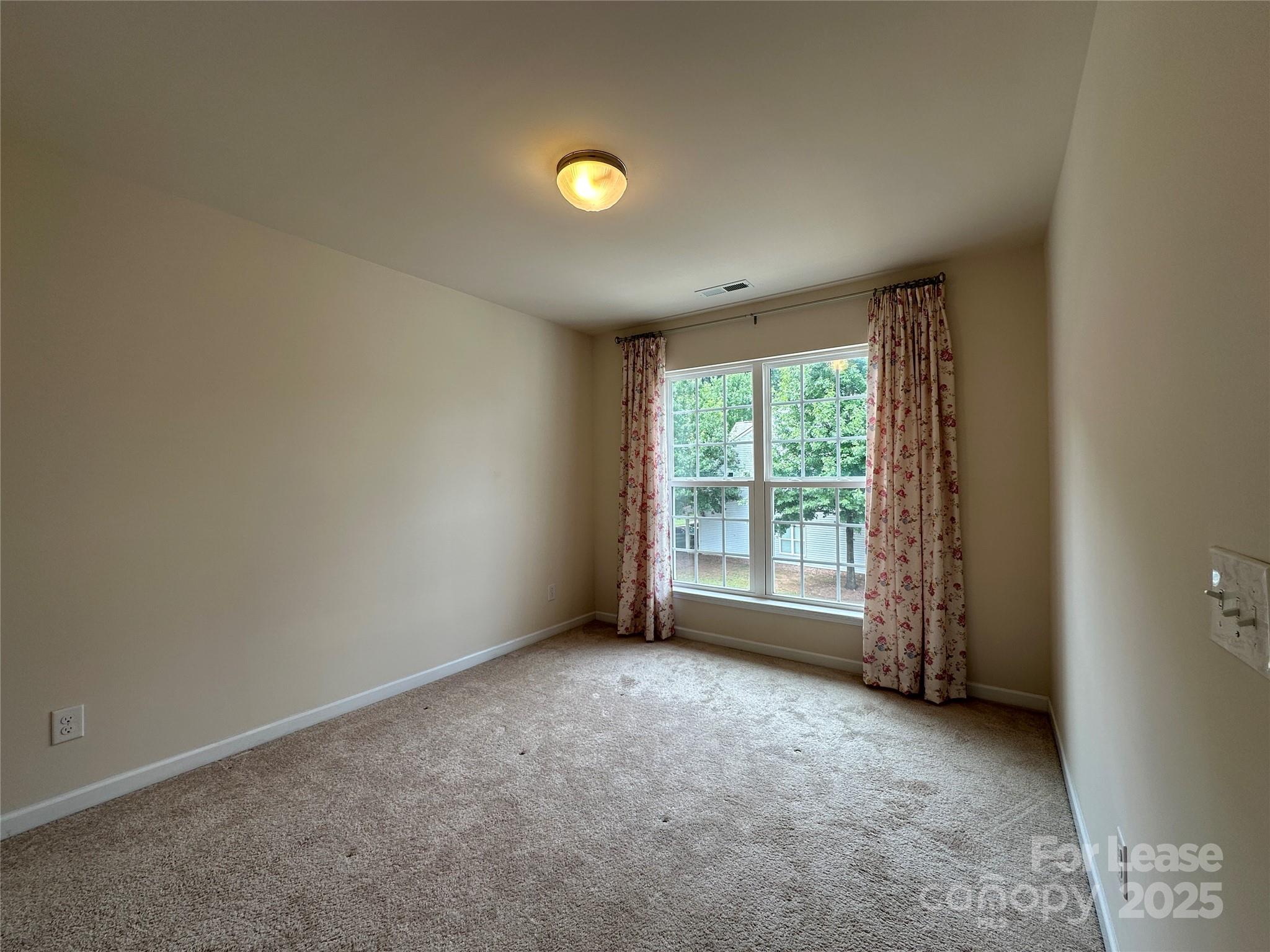 6516 Portland Rose Lane Charlotte, NC 28210 - Photo 19 of 22 an empty room with a empty space and a window