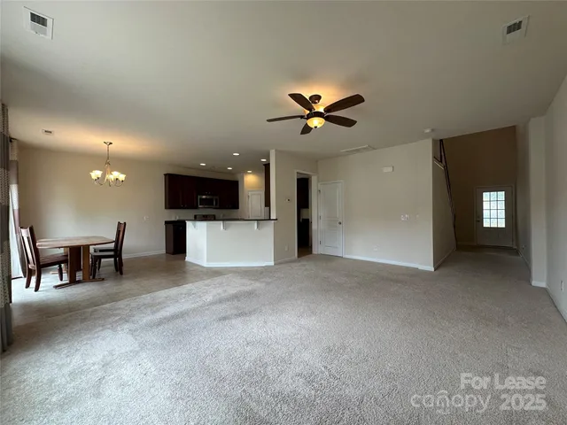 a view of a livingroom with furniture and a ceiling fan