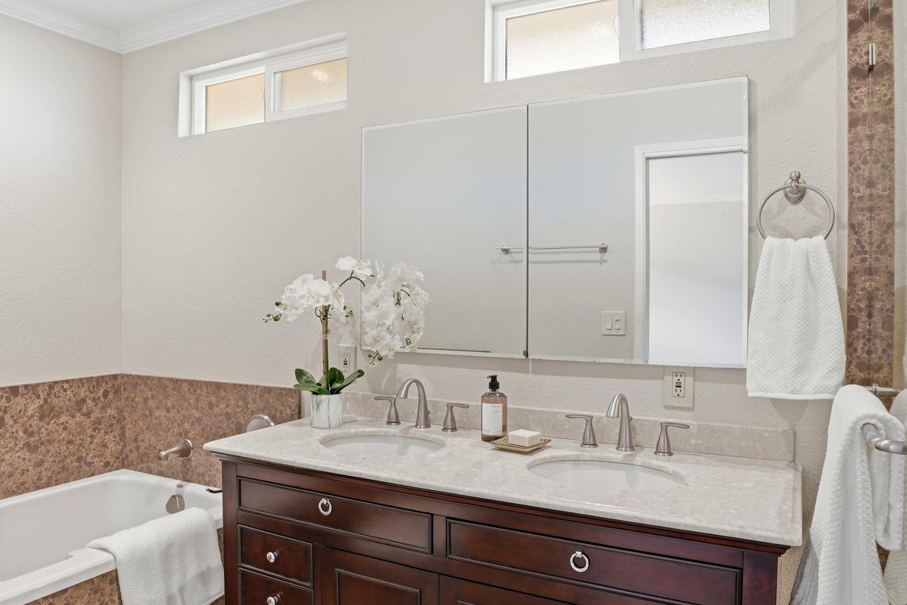 701 Archer Street Monterey, CA 93940 - Photo 16 of 39 a bathroom with a granite countertop sink and a mirror