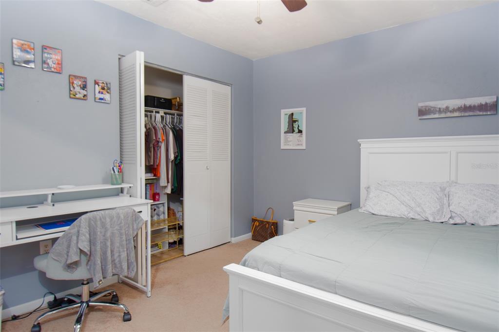 2300 Southwest 43rd Street, Unit K5 Gainesville, FL 32607 - Photo 5 of 18 a bedroom with a bed and a chair