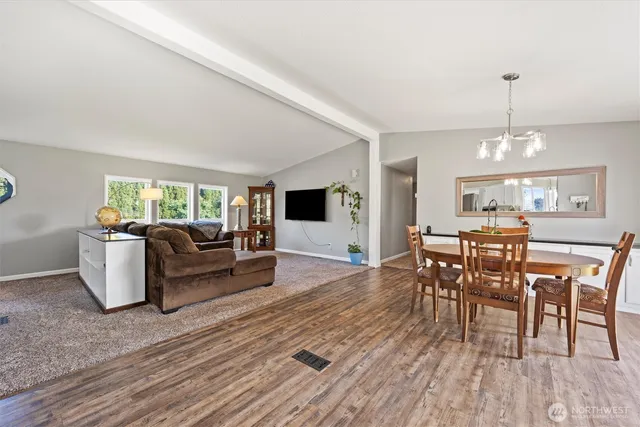a living room with furniture dining table and a flat screen tv