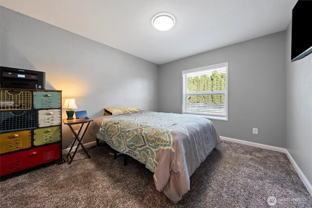 a bed sitting in a bedroom next to a window