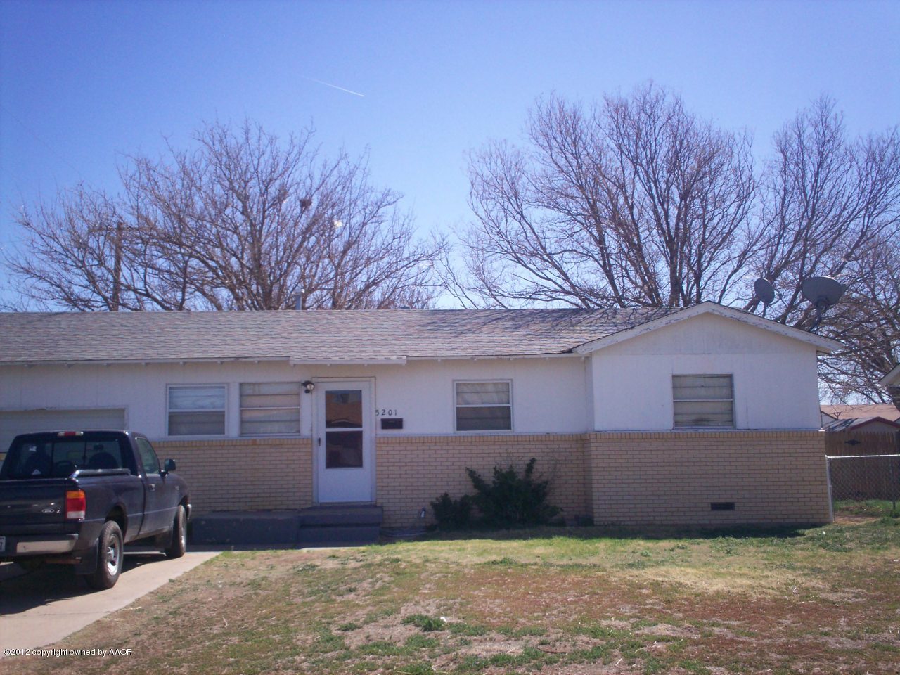 5201 South Travis Street Amarillo, TX 79110 - Photo 1 of 20 a front view of a house with a yard and garage