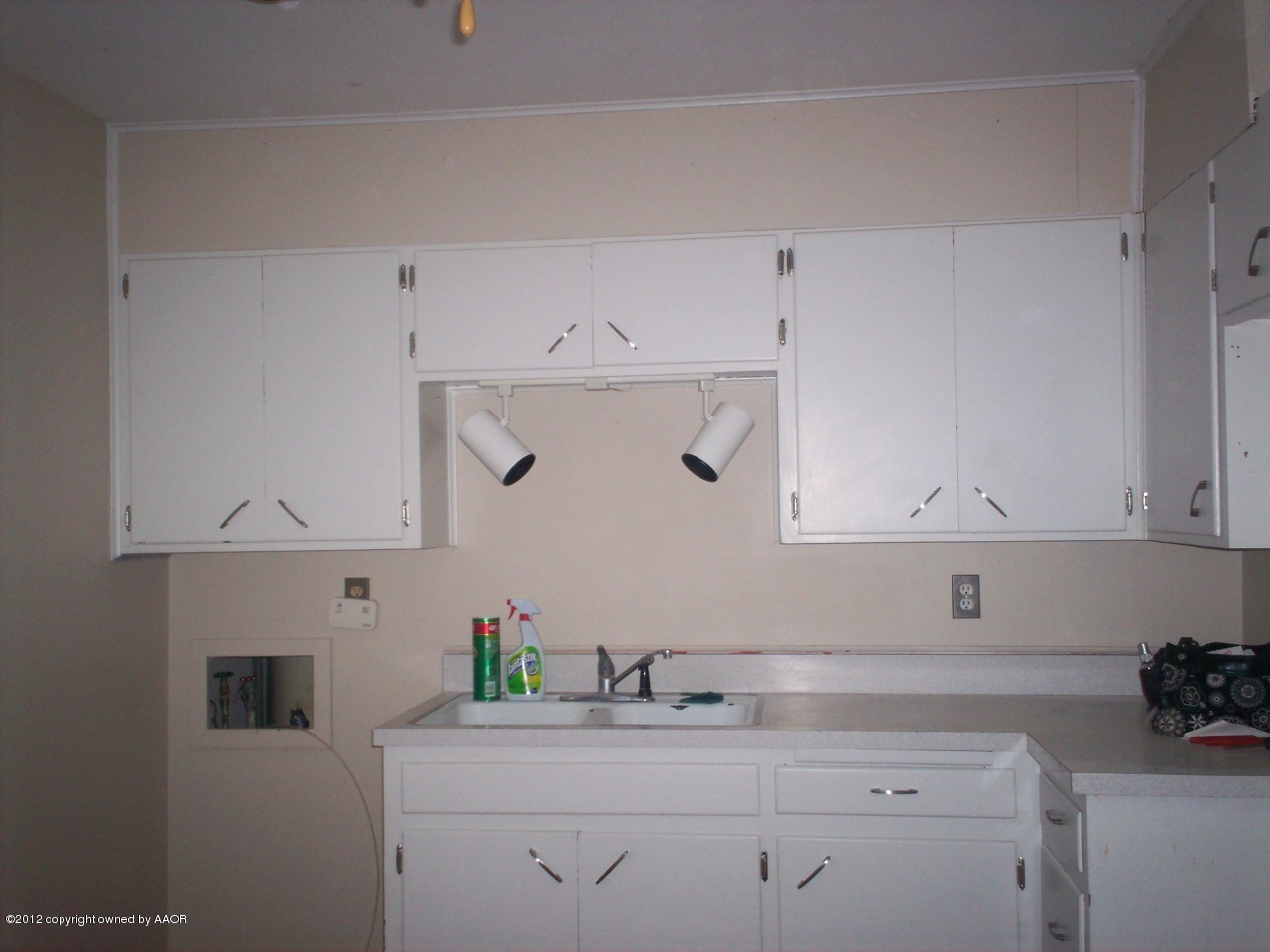 5201 South Travis Street Amarillo, TX 79110 - Photo 17 of 20 a kitchen with cabinets appliances and a sink