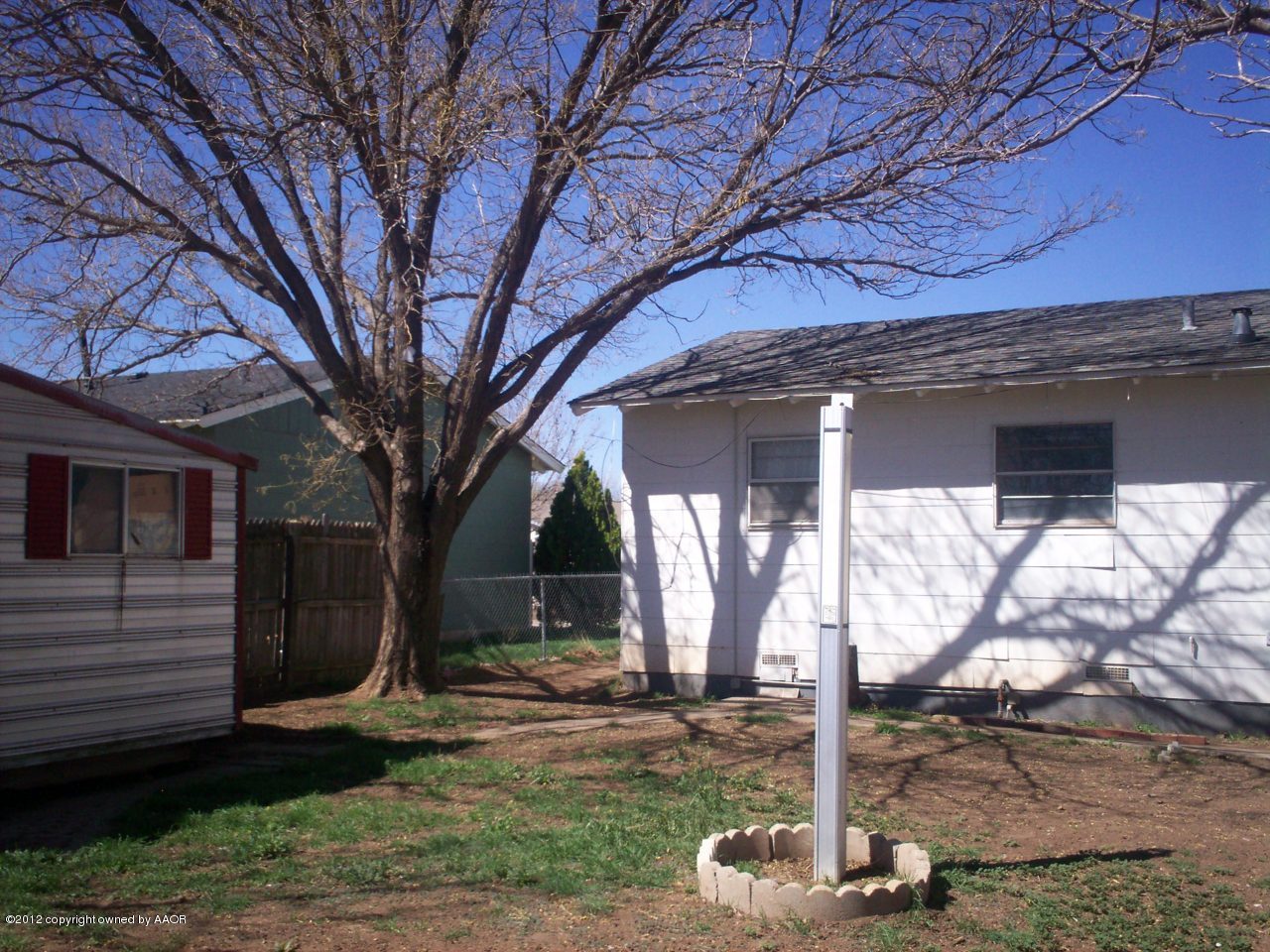 5201 South Travis Street Amarillo, TX 79110 - Photo 6 of 20 a front view of a house with a yard