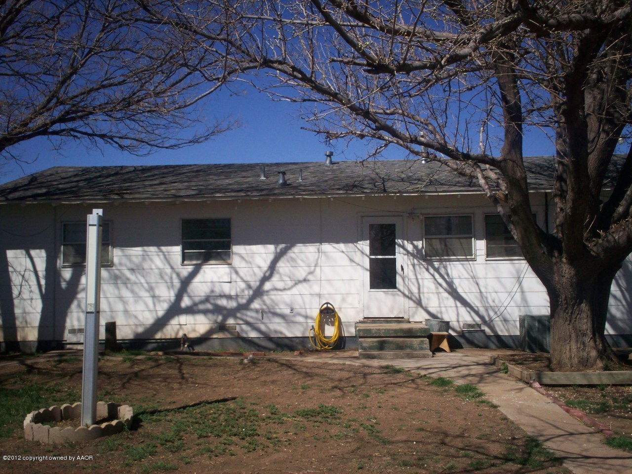 5201 South Travis Street Amarillo, TX 79110 - Photo 7 of 20 a view of a house with a tree