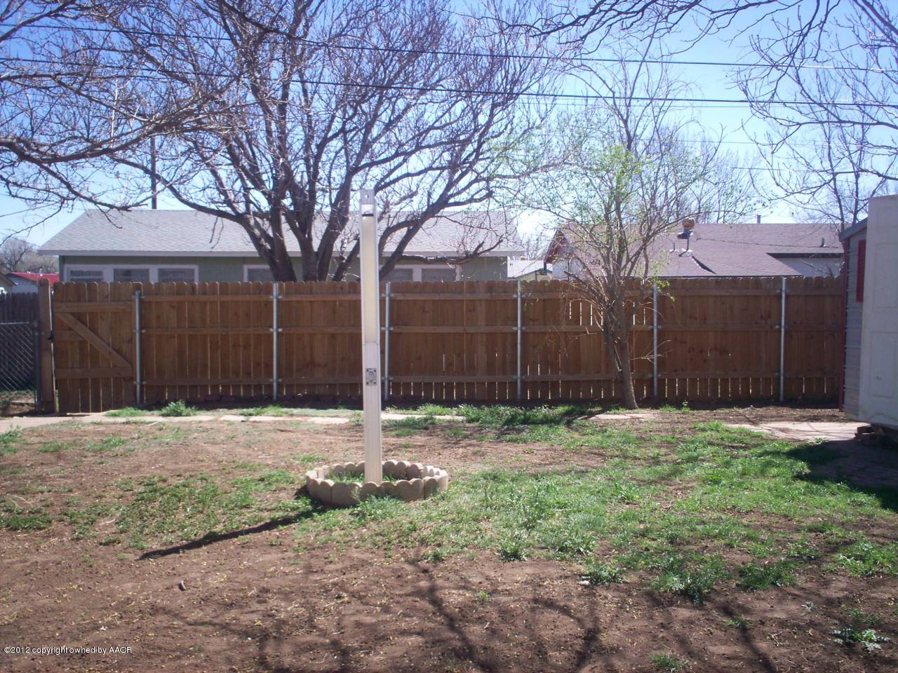 5201 South Travis Street Amarillo, TX 79110 - Photo 8 of 20 a backyard of house with large trees