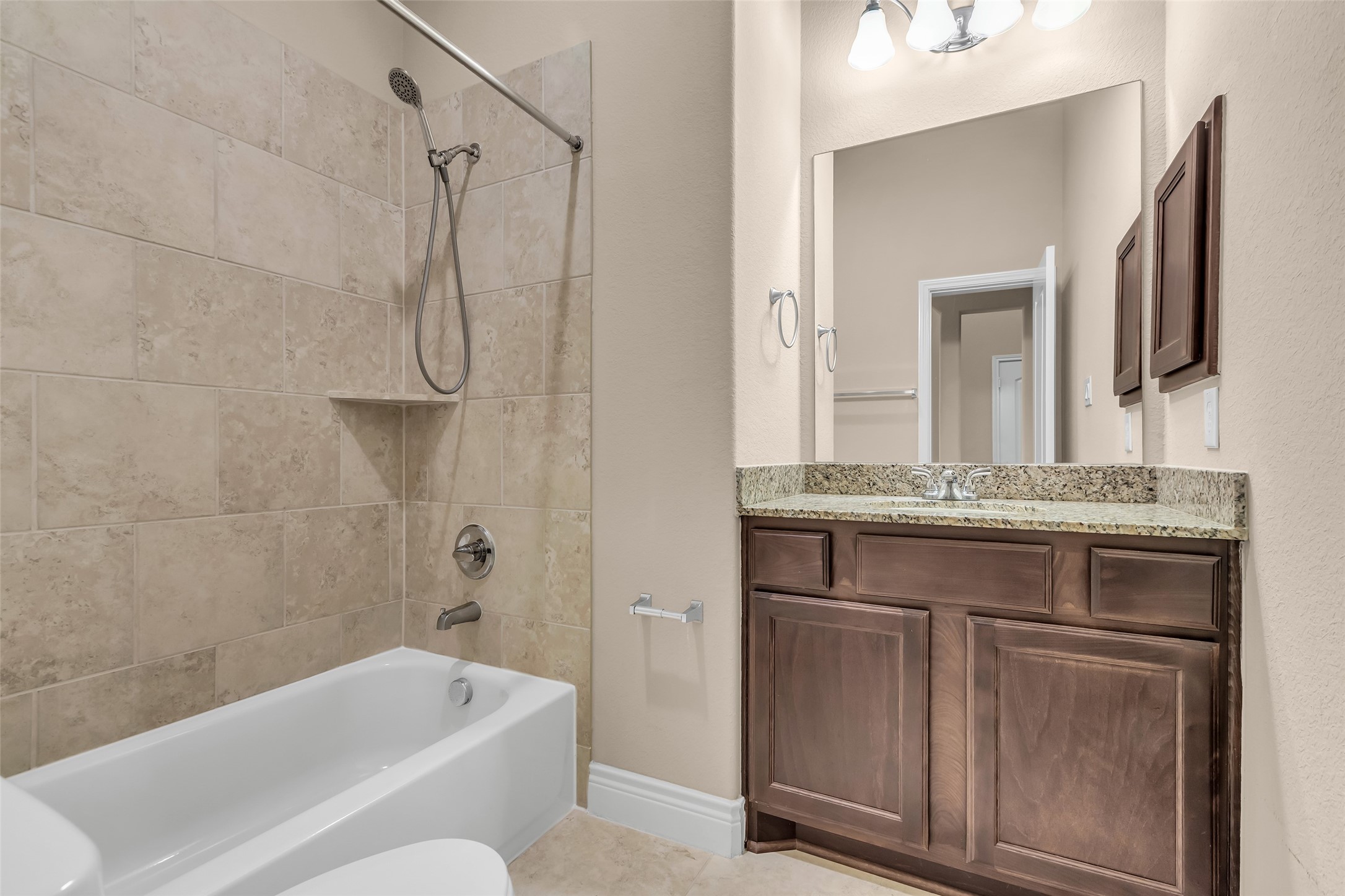 27946 Emory Cove Drive Spring, TX 77386 - Photo 23 of 25 a bathroom with a granite countertop sink a toilet and shower