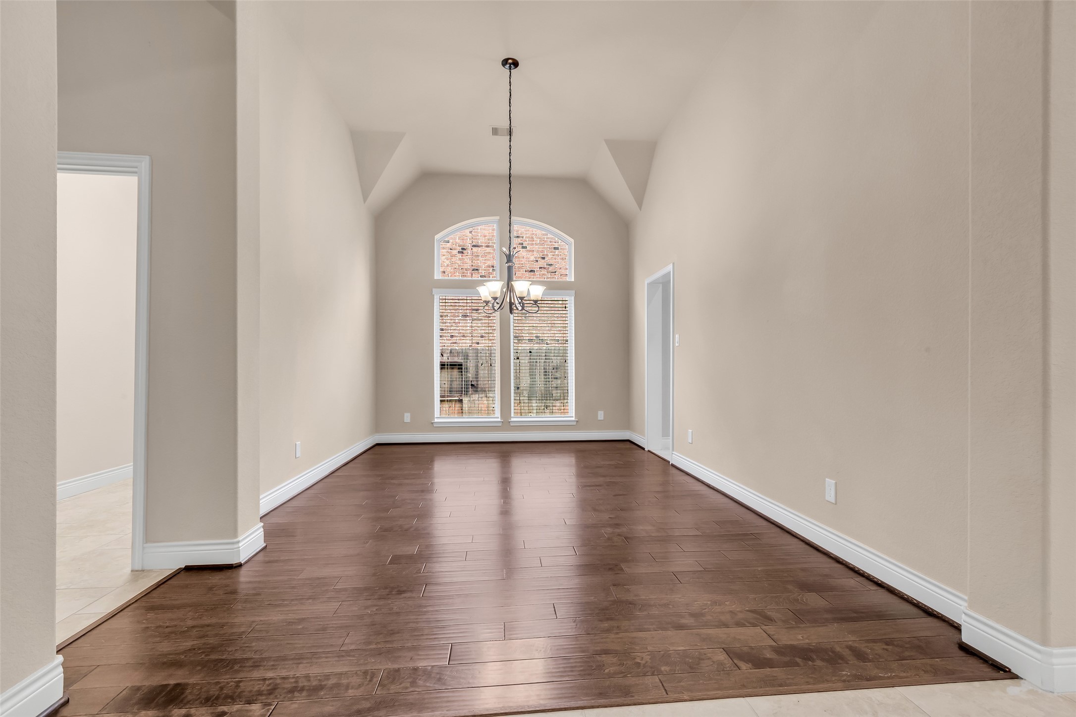 27946 Emory Cove Drive Spring, TX 77386 - Photo 4 of 25 a view of an empty room with wooden floor and a window