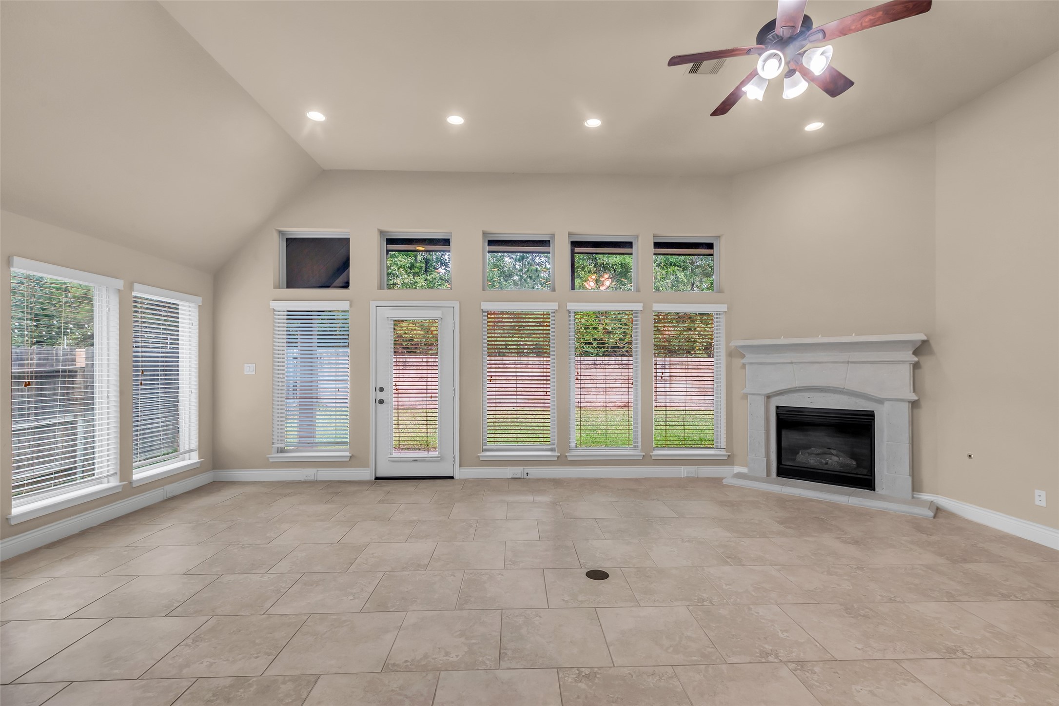 27946 Emory Cove Drive Spring, TX 77386 - Photo 10 of 25 a view of an empty room with a fireplace and a window