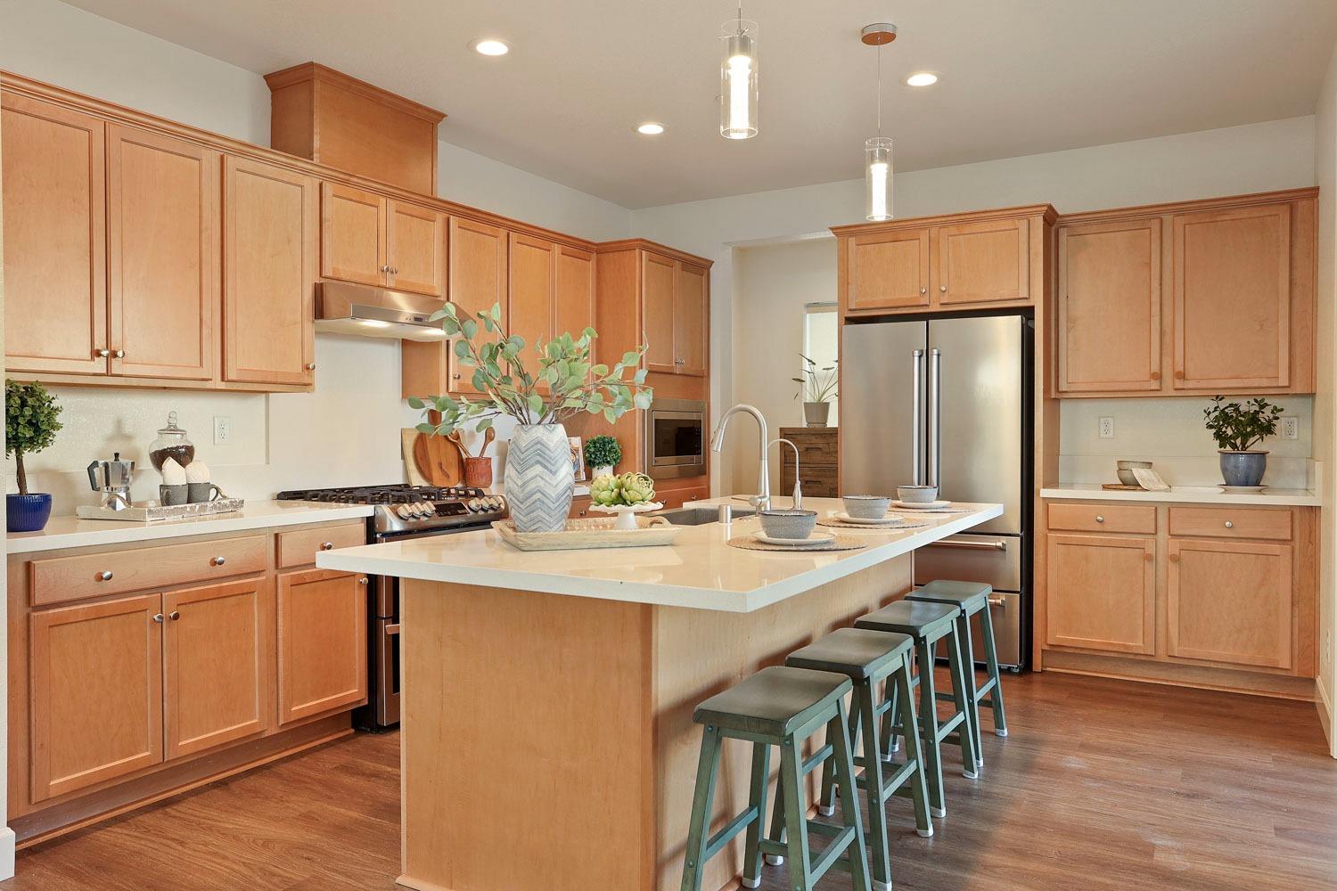 3081 Rio Grande Drive Tracy, CA 95377 - Photo 12 of 60 a kitchen with kitchen island granite countertop a sink a center island and stainless steel appliances