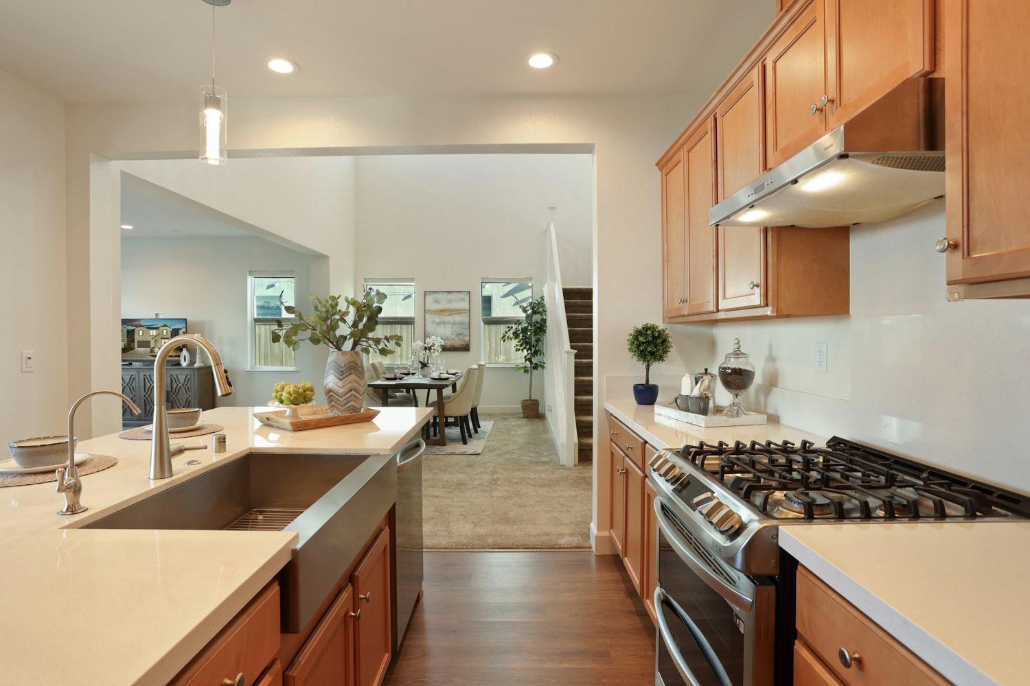 3081 Rio Grande Drive Tracy, CA 95377 - Photo 14 of 60 a kitchen with stainless steel appliances a sink a stove top oven a counter space and cabinets