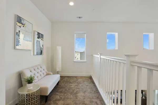 a view of a room with wooden floor and potted plant