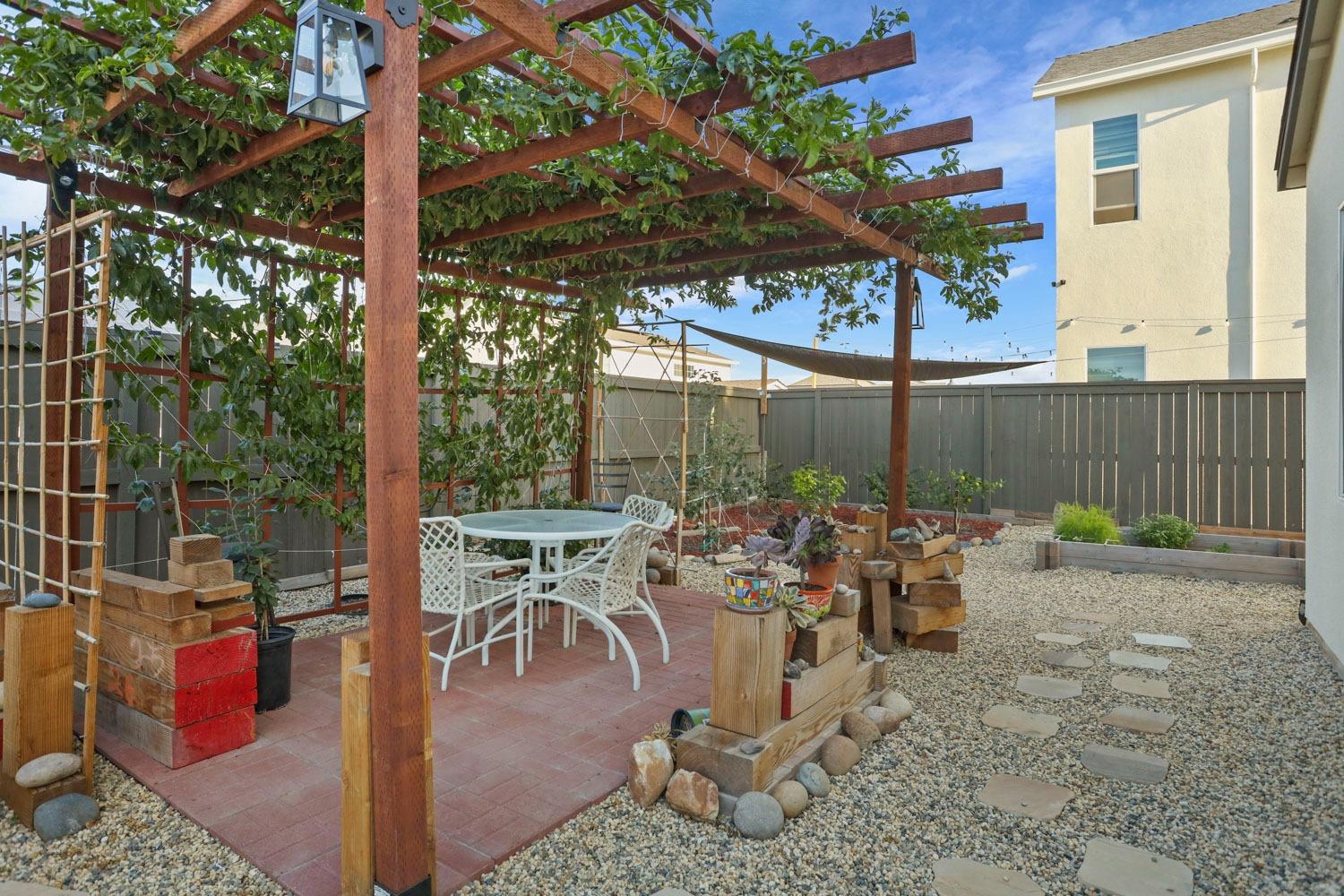 3081 Rio Grande Drive Tracy, CA 95377 - Photo 52 of 60 a view of a patio with table and chairs potted plants and floor to ceiling window