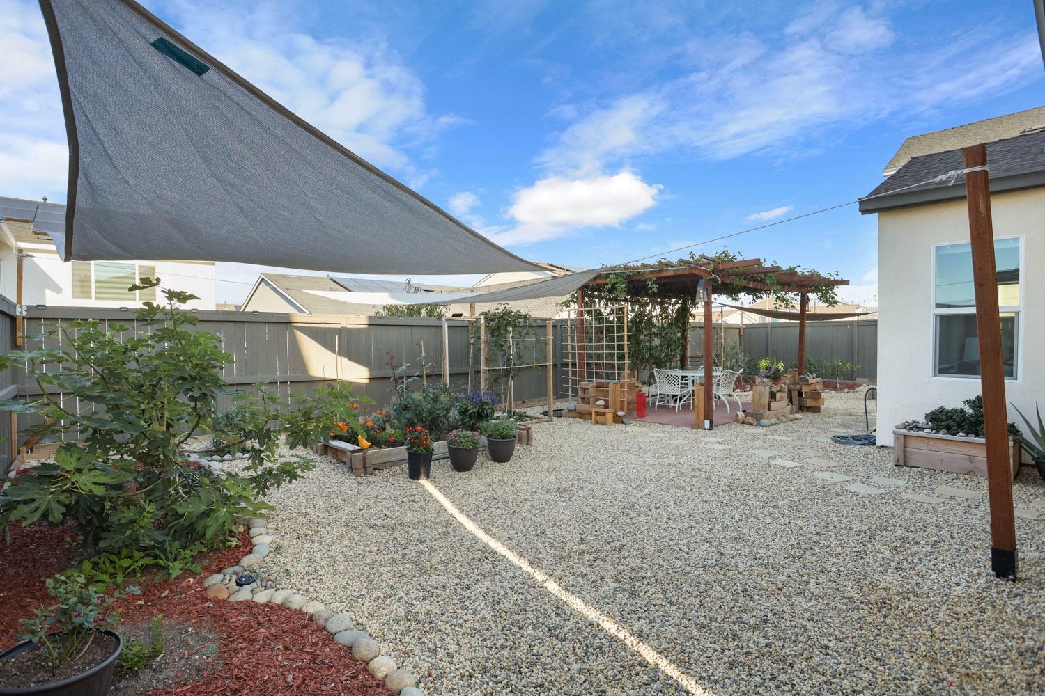 3081 Rio Grande Drive Tracy, CA 95377 - Photo 59 of 60 a view of a patio with a table and chairs under an umbrella