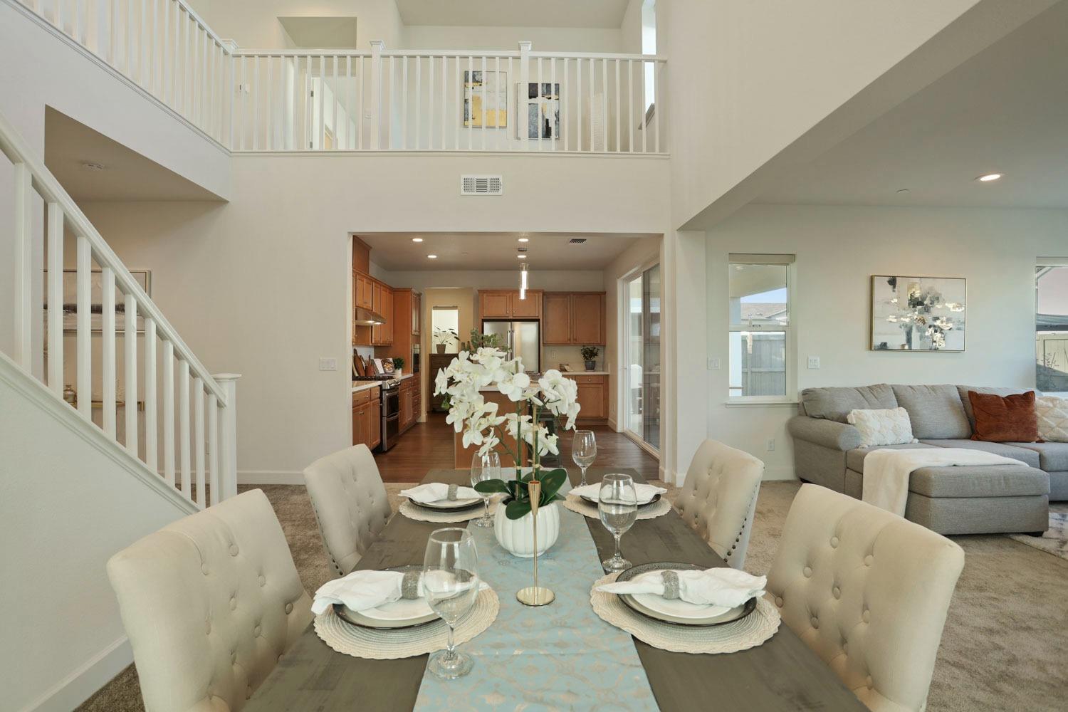 3081 Rio Grande Drive Tracy, CA 95377 - Photo 10 of 60 a living room with furniture a dining table and a chandelier