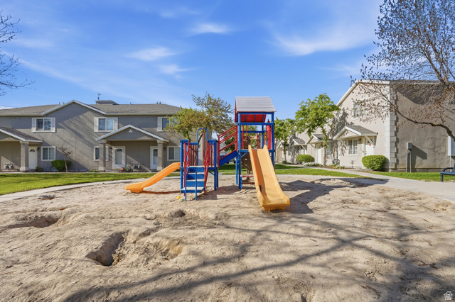 99 Penhurst Place Logan, UT 84341 - Photo 27 of 34 Community playground featuring a sand base, two slides, and climbing structures
