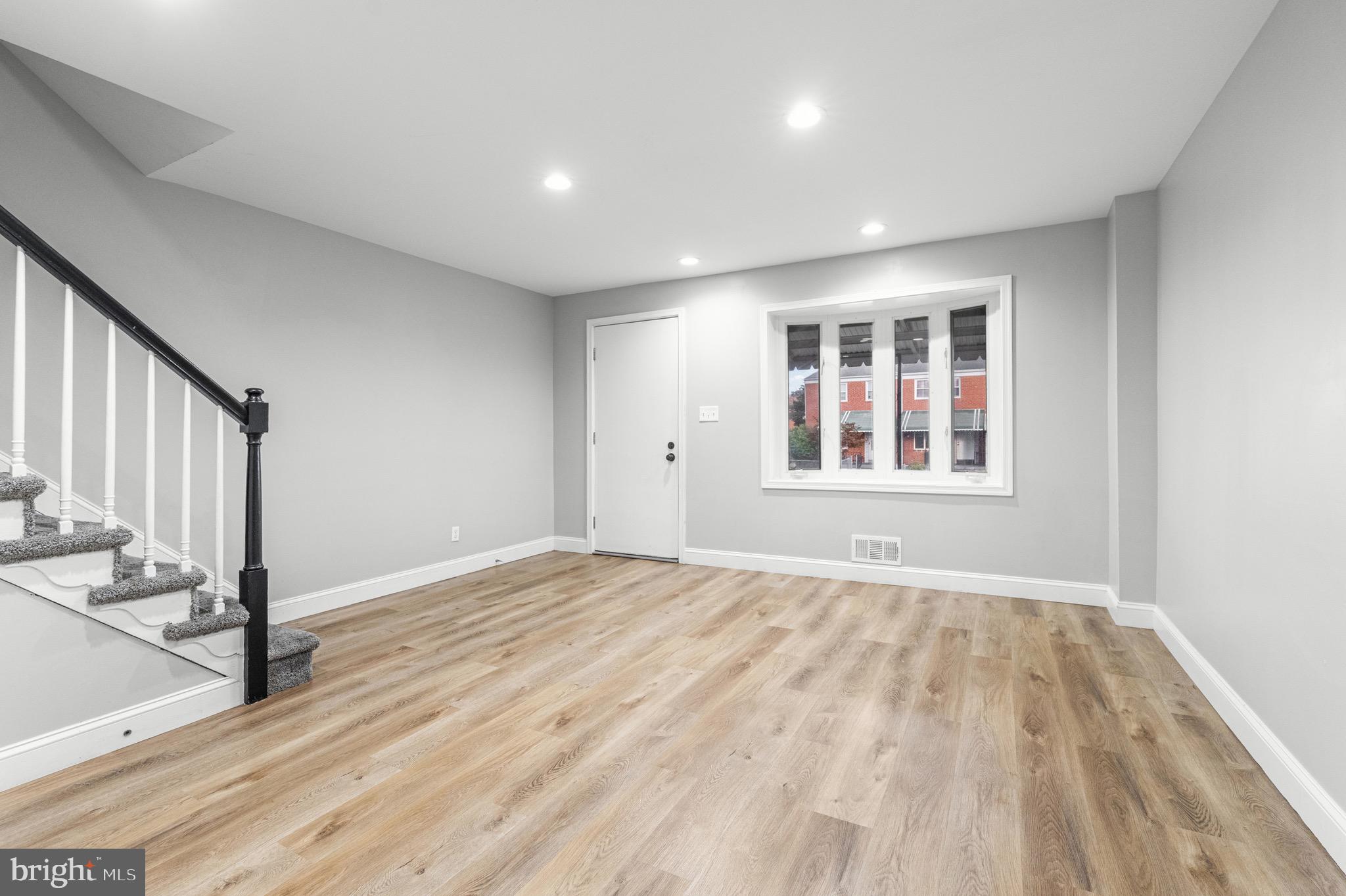 2203 Redthorn Road Baltimore, MD 21220 - Photo 3 of 23 a view of empty room with wooden floor and fan