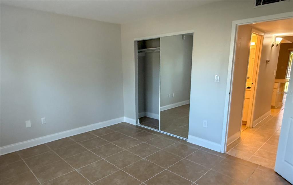 377 South McMullen Booth Road, Unit 97 Clearwater, FL 33759 - Photo 5 of 21 an empty room with mirror