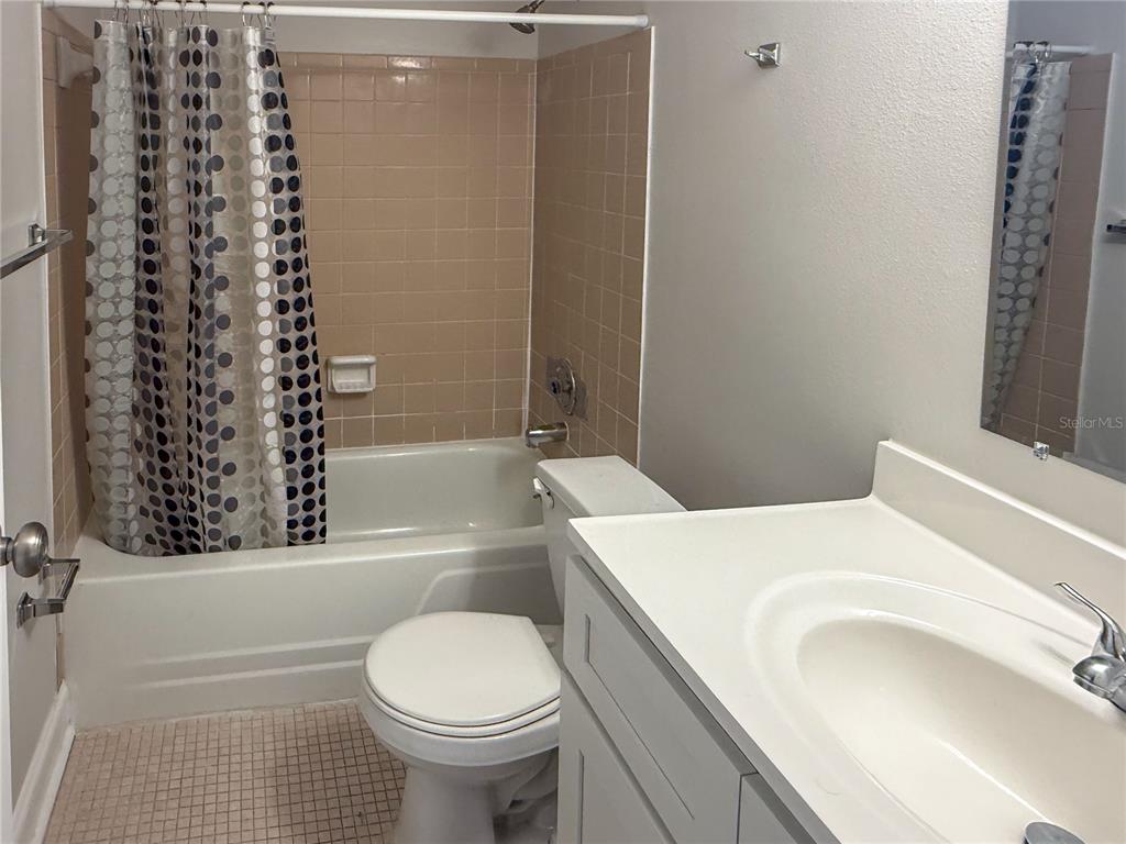 377 South McMullen Booth Road, Unit 97 Clearwater, FL 33759 - Photo 6 of 21 a bathroom with a sink toilet and shower