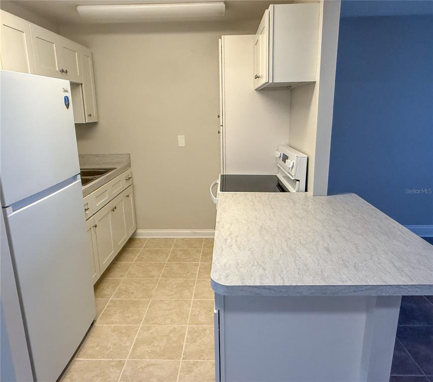 377 South McMullen Booth Road, Unit 97 Clearwater, FL 33759 - Photo 8 of 21 a kitchen with stainless steel appliances a refrigerator and a stove