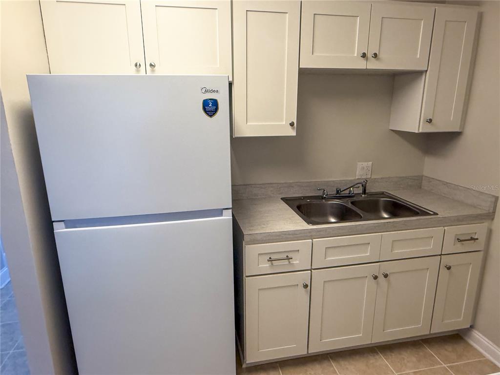 377 South McMullen Booth Road, Unit 97 Clearwater, FL 33759 - Photo 9 of 21 a white refrigerator freezer sitting inside of a kitchen