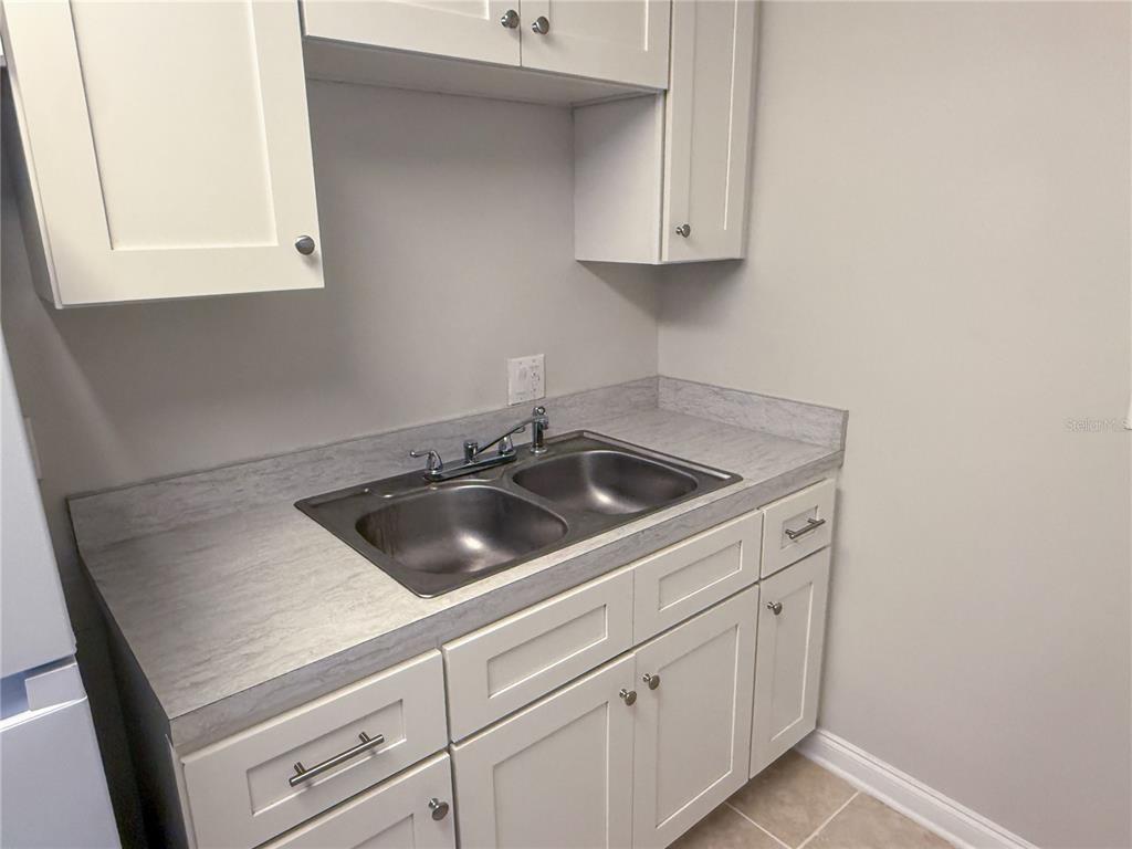 377 South McMullen Booth Road, Unit 97 Clearwater, FL 33759 - Photo 10 of 21 a kitchen with a sink and cabinets