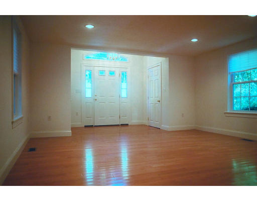 234 Old Stonebridge Road Wayland, MA 01778 - Photo 3 of 8 a view of an empty room with wooden floor and windows