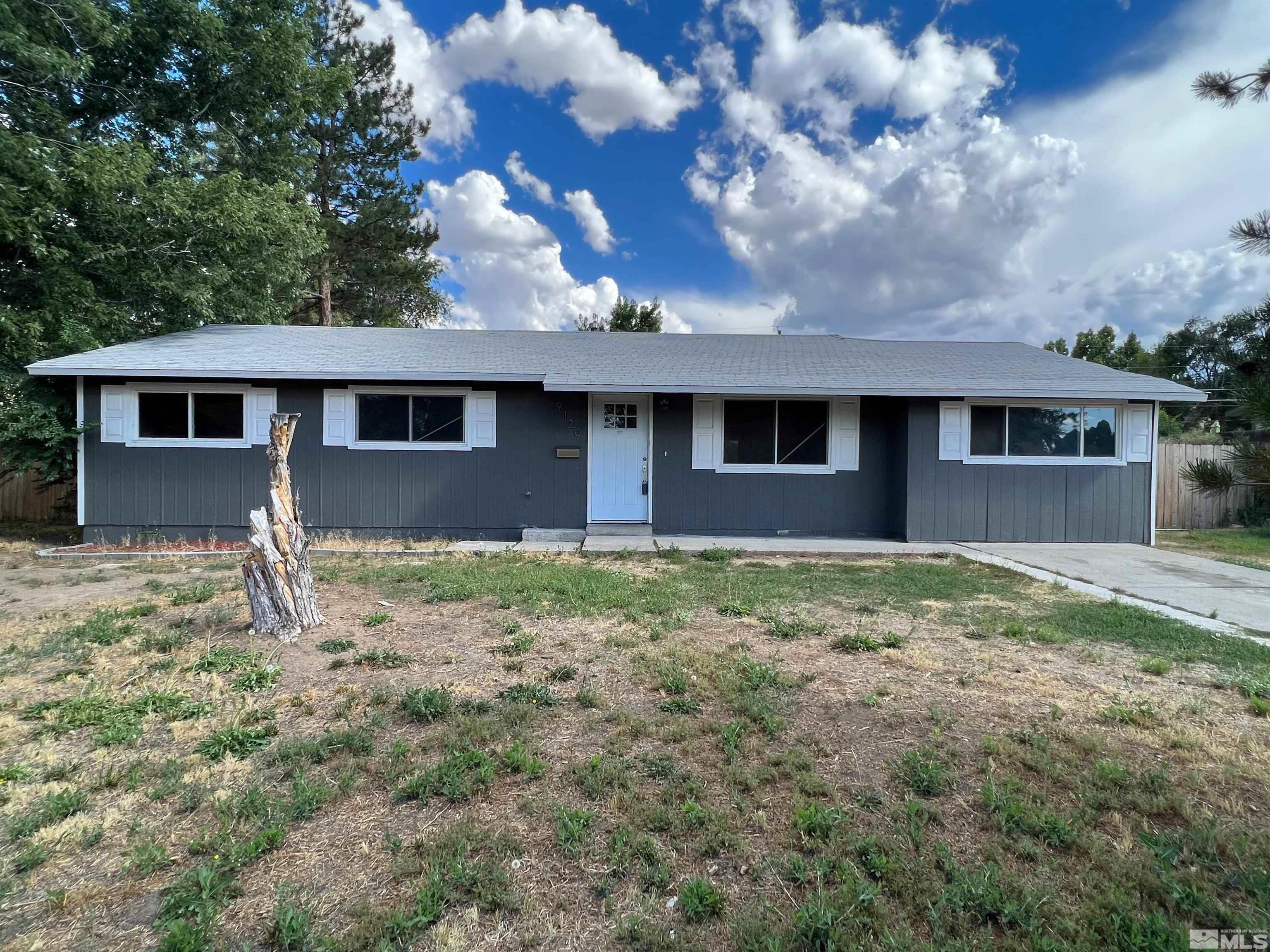 9120 Fremont Way Reno, NV 89506 - Photo 2 of 15 a front view of a house with garden
