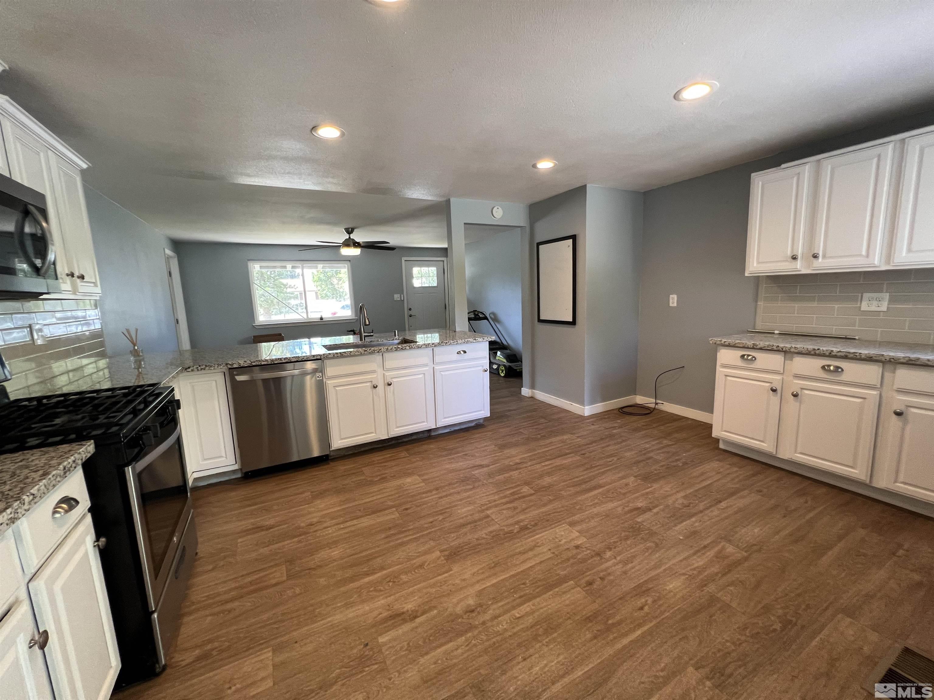 9120 Fremont Way Reno, NV 89506 - Photo 4 of 15 a kitchen with a sink cabinets and wooden floor