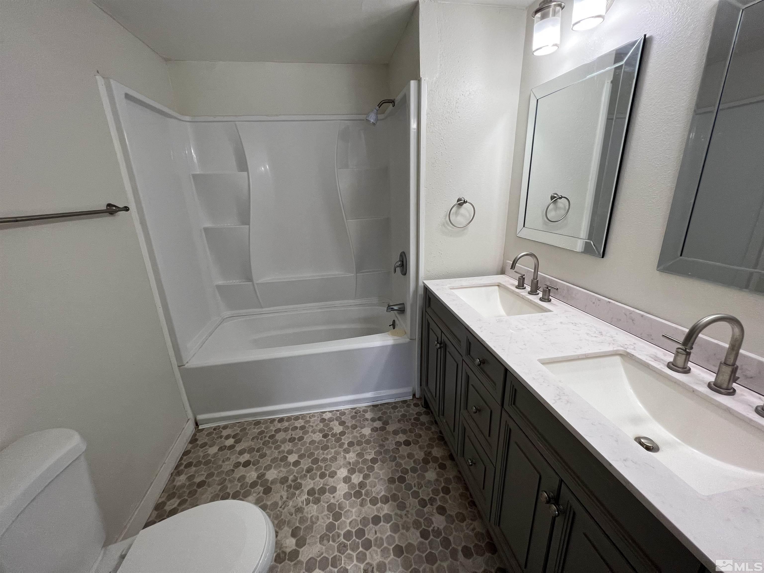 9120 Fremont Way Reno, NV 89506 - Photo 7 of 15 a bathroom with a double vanity sink toilet and shower