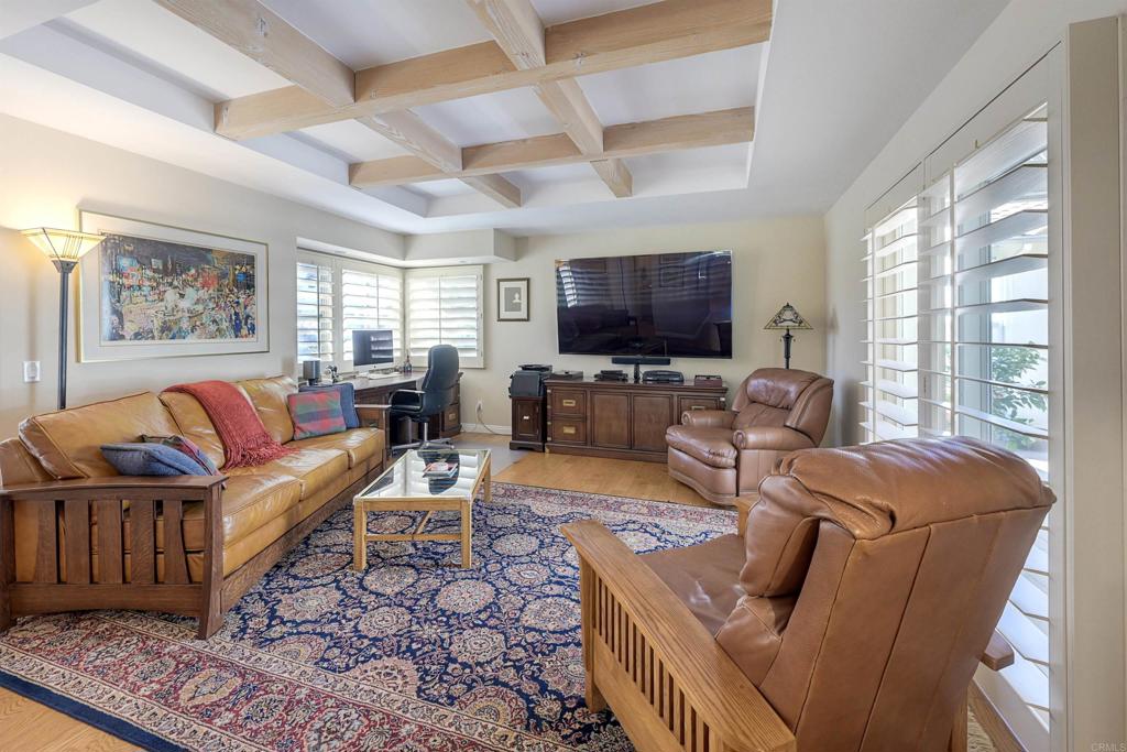 16142 El Tae Road Pauma Valley, CA 92061 - Photo 17 of 63 a living room with furniture a flat screen tv and a large window