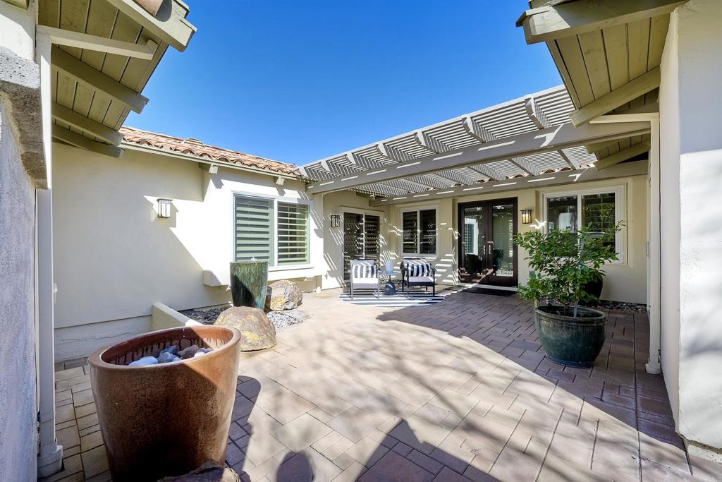 16142 El Tae Road Pauma Valley, CA 92061 - Photo 2 of 63 a view of a chair and tables in the patio of the house