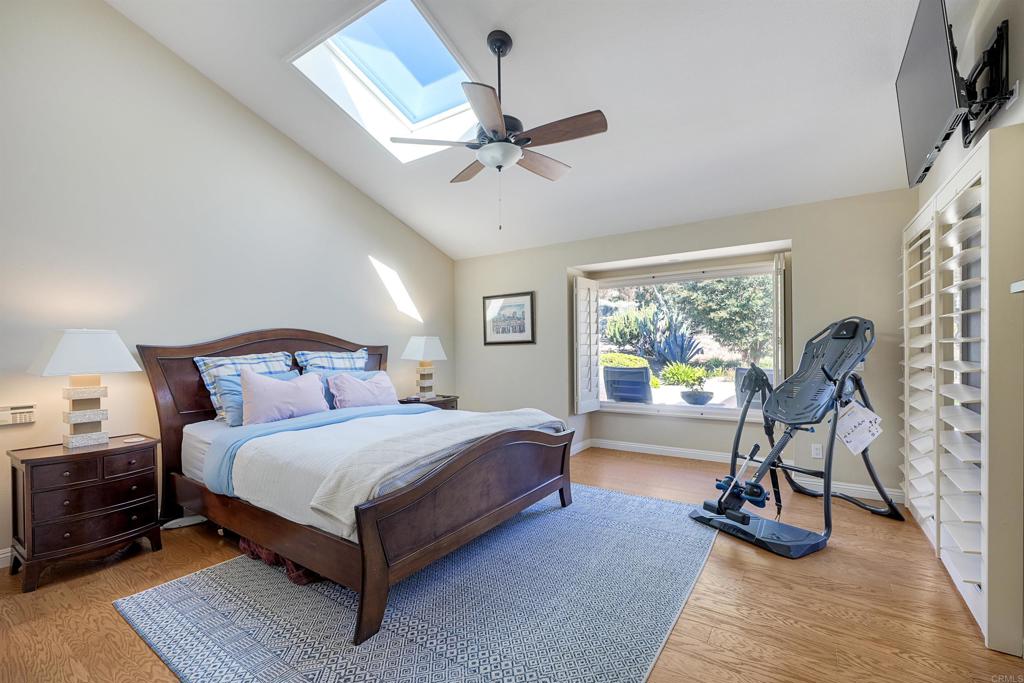 16142 El Tae Road Pauma Valley, CA 92061 - Photo 23 of 63 a bedroom with a bed and a chandelier